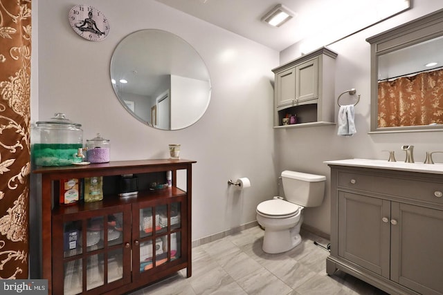 bathroom with baseboards, visible vents, vanity, and toilet