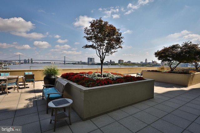 view of patio with a water view and a city view