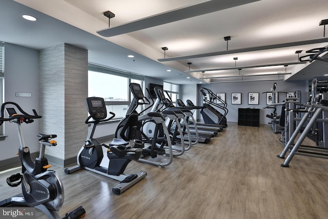 workout area with wood finished floors and recessed lighting