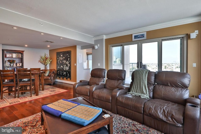 living area with recessed lighting, wood finished floors, visible vents, and crown molding