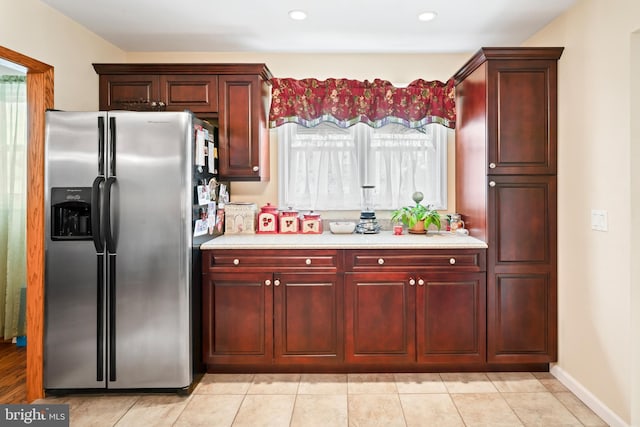 kitchen featuring light countertops, dark brown cabinets, recessed lighting, and stainless steel fridge with ice dispenser