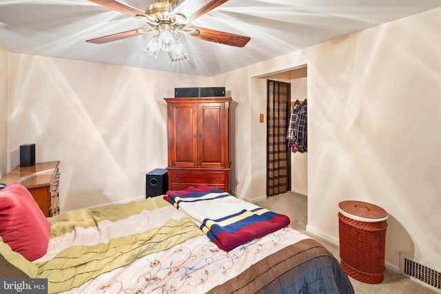 carpeted bedroom featuring ceiling fan, visible vents, and baseboards