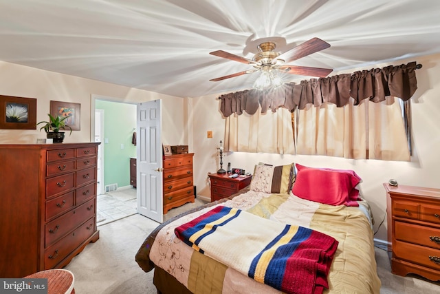 bedroom with light carpet, baseboards, visible vents, and a ceiling fan