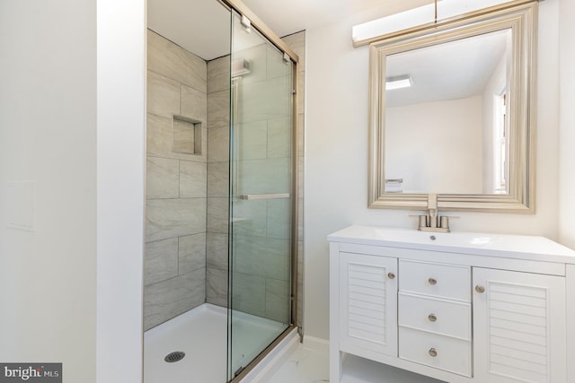 bathroom featuring a shower stall and vanity