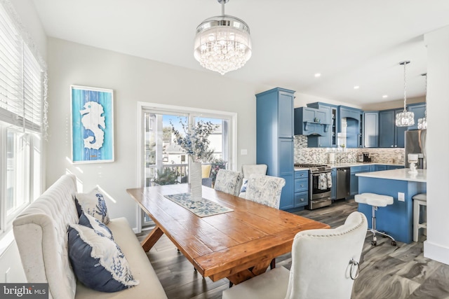 dining space with dark wood-style floors, recessed lighting, and a notable chandelier