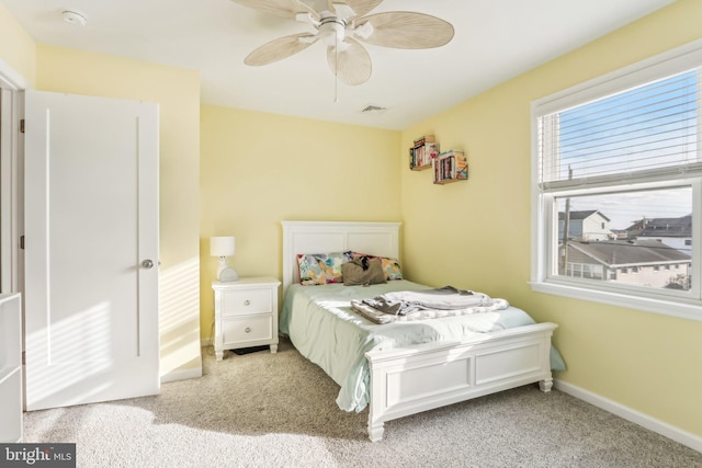 carpeted bedroom featuring visible vents, ceiling fan, and baseboards