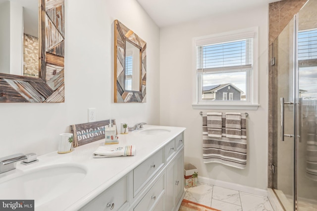 bathroom featuring plenty of natural light, marble finish floor, a sink, and double vanity