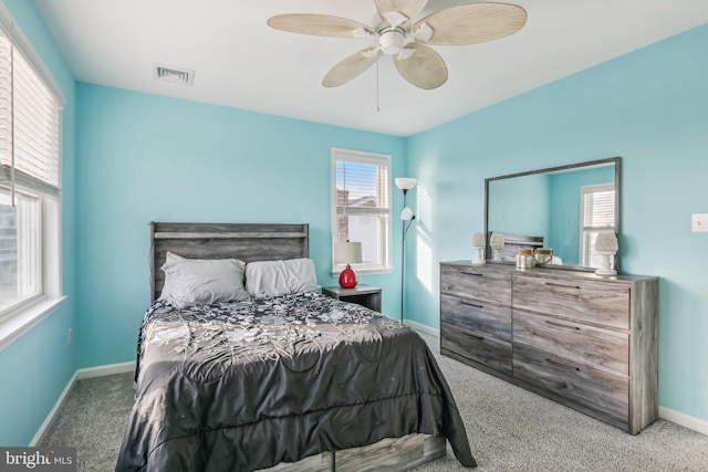 bedroom with carpet flooring, visible vents, ceiling fan, and baseboards