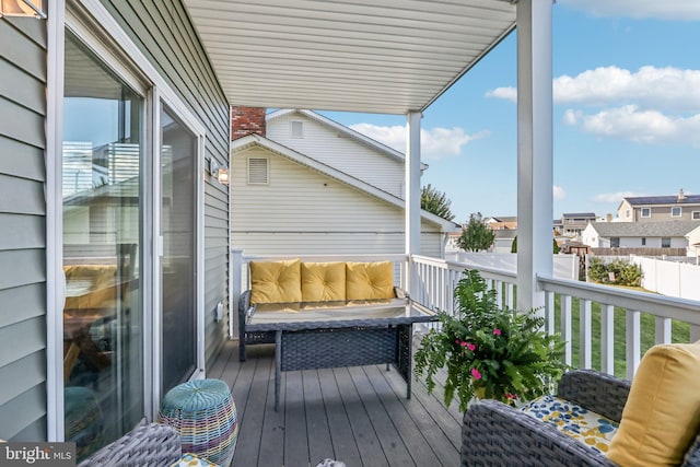 view of wooden balcony with a deck and a residential view