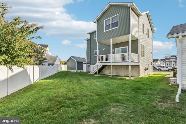 back of house featuring stairway, a residential view, fence, and a yard