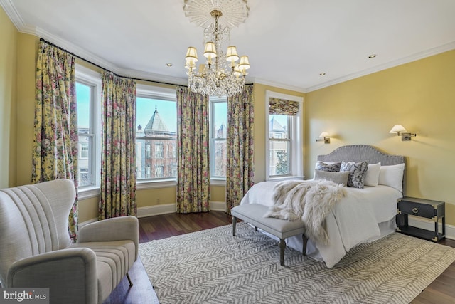 bedroom with baseboards, wood finished floors, crown molding, a chandelier, and recessed lighting