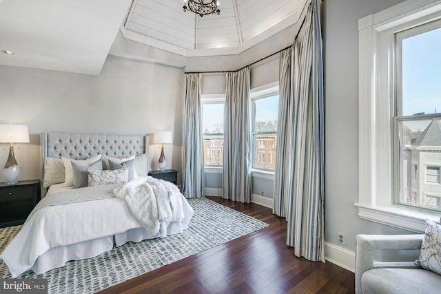 bedroom with baseboards, wood finished floors, and recessed lighting