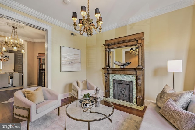 living room with a chandelier, a fireplace with flush hearth, and wood finished floors