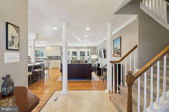 foyer with visible vents, ornamental molding, recessed lighting, decorative columns, and stairs