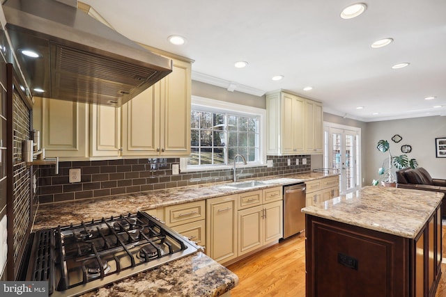 kitchen with stainless steel dishwasher, extractor fan, and cream cabinetry