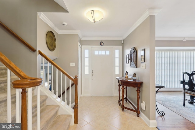 foyer entrance featuring stairway, baseboards, and ornamental molding