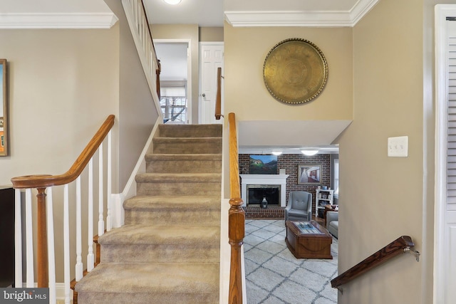 stairway featuring a fireplace and crown molding