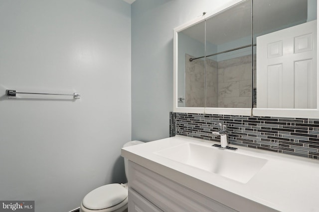 full bath with decorative backsplash, toilet, vanity, and a tile shower