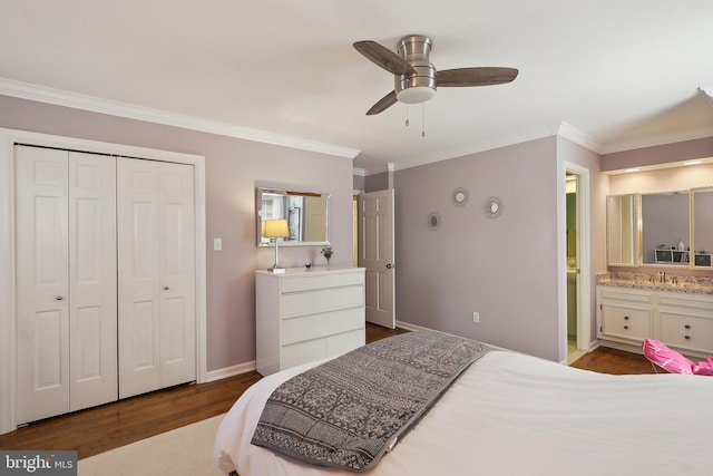 bedroom featuring a closet, ensuite bathroom, crown molding, and wood finished floors