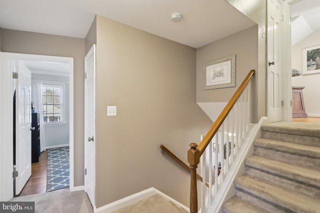 stairs with baseboards and wood finished floors