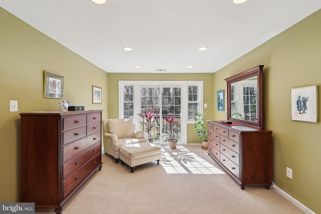 living area with recessed lighting, visible vents, baseboards, and light colored carpet