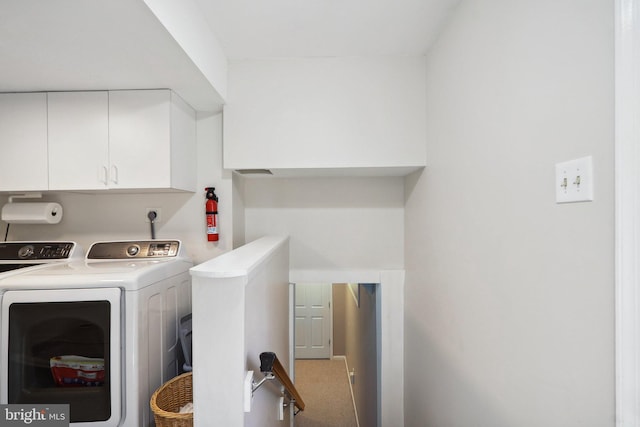 laundry area with carpet, cabinet space, and washing machine and dryer