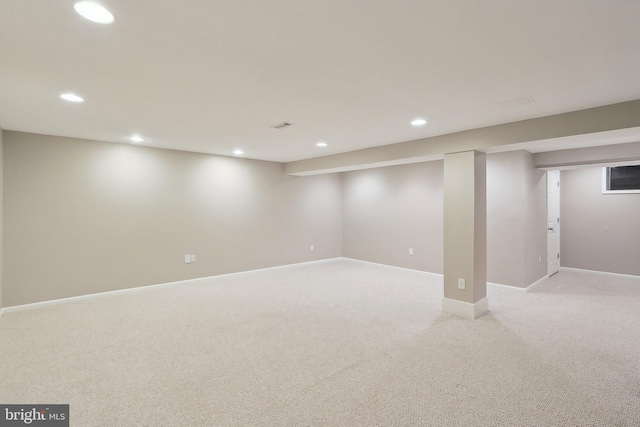 finished below grade area with recessed lighting, baseboards, and light colored carpet