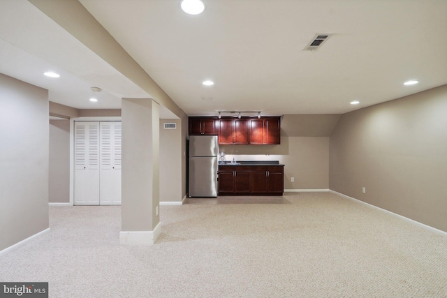 kitchen featuring recessed lighting, light colored carpet, baseboards, and freestanding refrigerator