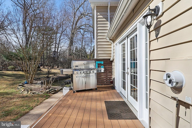 deck featuring french doors and a grill