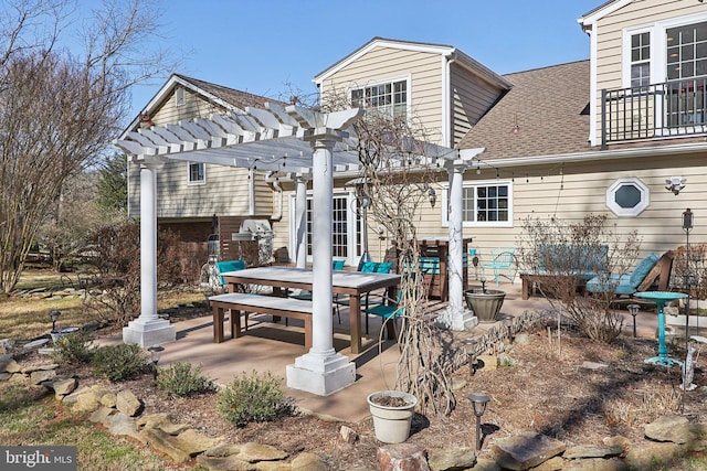 back of property featuring a patio, outdoor dining area, a pergola, and a shingled roof