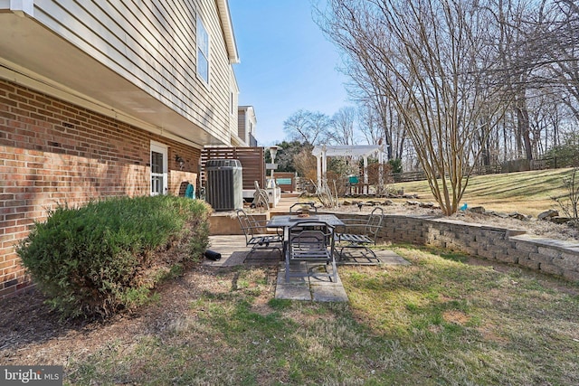 view of yard featuring central AC unit, a pergola, and a patio