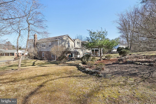 exterior space with a yard and a chimney