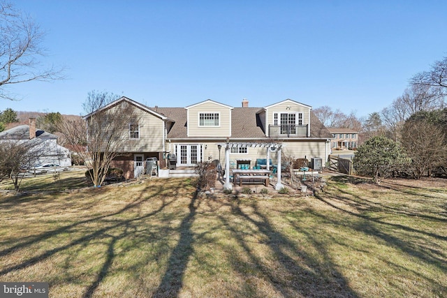 rear view of house with french doors, a yard, a patio area, and fence