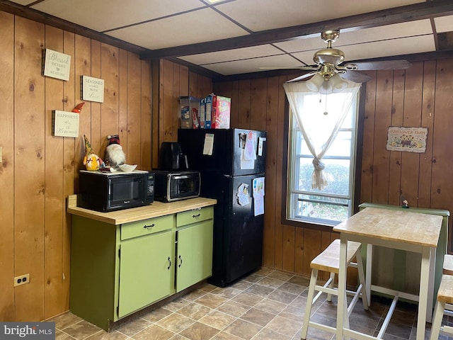 kitchen with a toaster, light countertops, green cabinets, ceiling fan, and black appliances