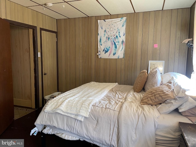 bedroom with wooden walls