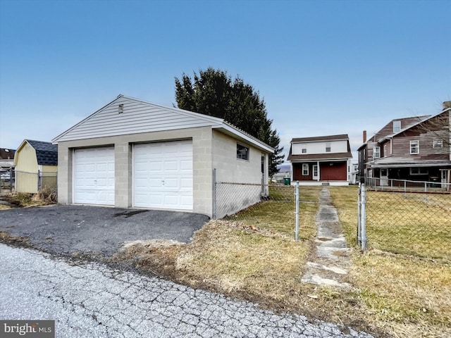 detached garage featuring fence