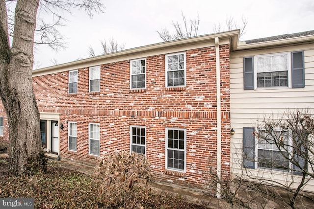 view of side of property with brick siding