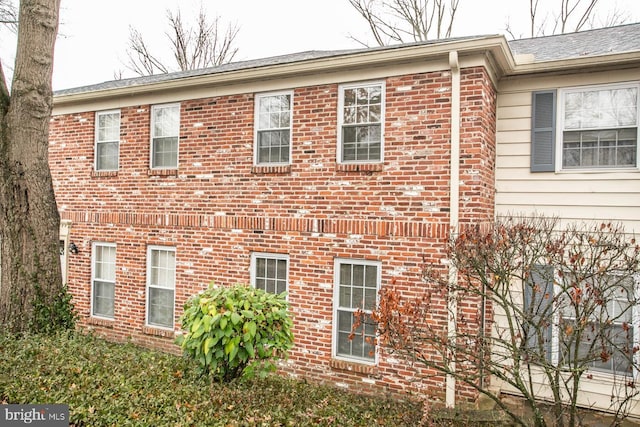 view of property exterior with brick siding