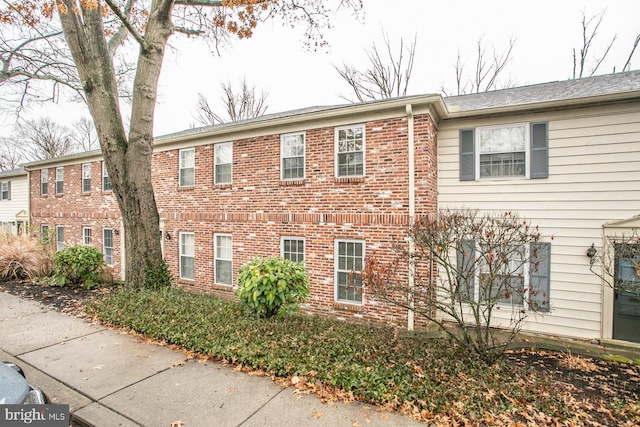 view of side of home featuring brick siding