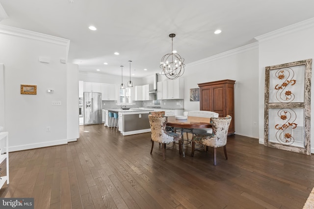 dining space with dark wood-style floors, crown molding, recessed lighting, an inviting chandelier, and baseboards