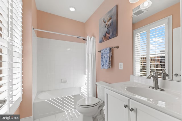 bathroom featuring toilet, visible vents, vanity, tile patterned floors, and shower / bath combo with shower curtain