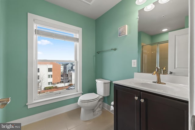 bathroom featuring tile patterned flooring, toilet, vanity, baseboards, and a shower stall