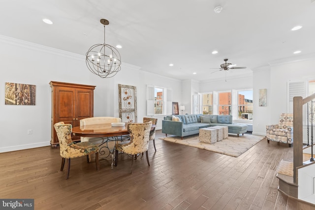 dining space with baseboards, wood finished floors, and crown molding