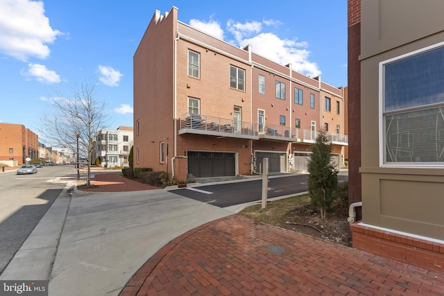 view of property featuring a garage and a residential view