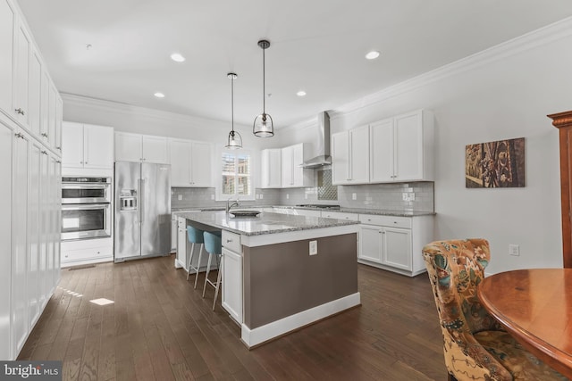 kitchen with wall chimney exhaust hood, appliances with stainless steel finishes, dark wood-type flooring, and crown molding