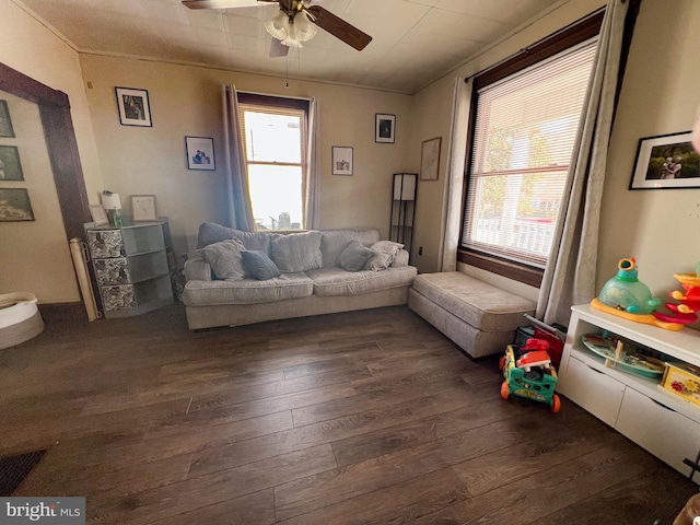 living area with dark wood-style floors and a ceiling fan