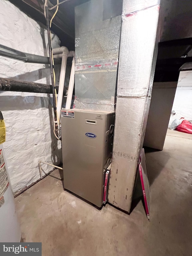 utility room with water heater and heating unit