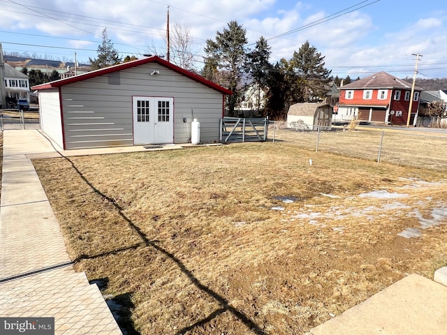 view of yard featuring an outbuilding and fence