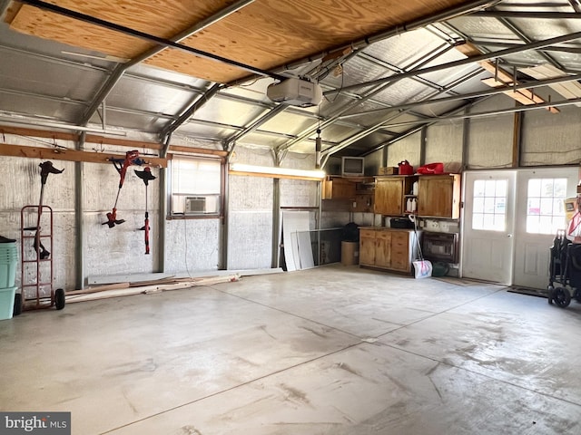 garage with a garage door opener and cooling unit