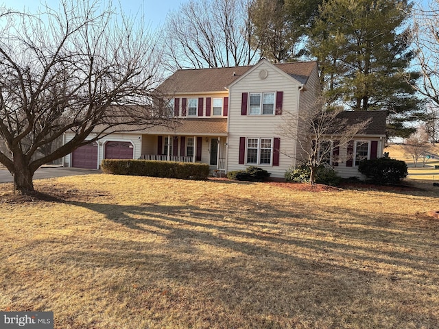 view of front of home with concrete driveway, a front lawn, and an attached garage